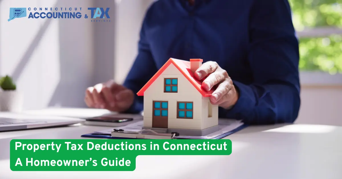 A person reviewing property tax documents with a small house model on a desk, representing Connecticut homeowner tax deductions.